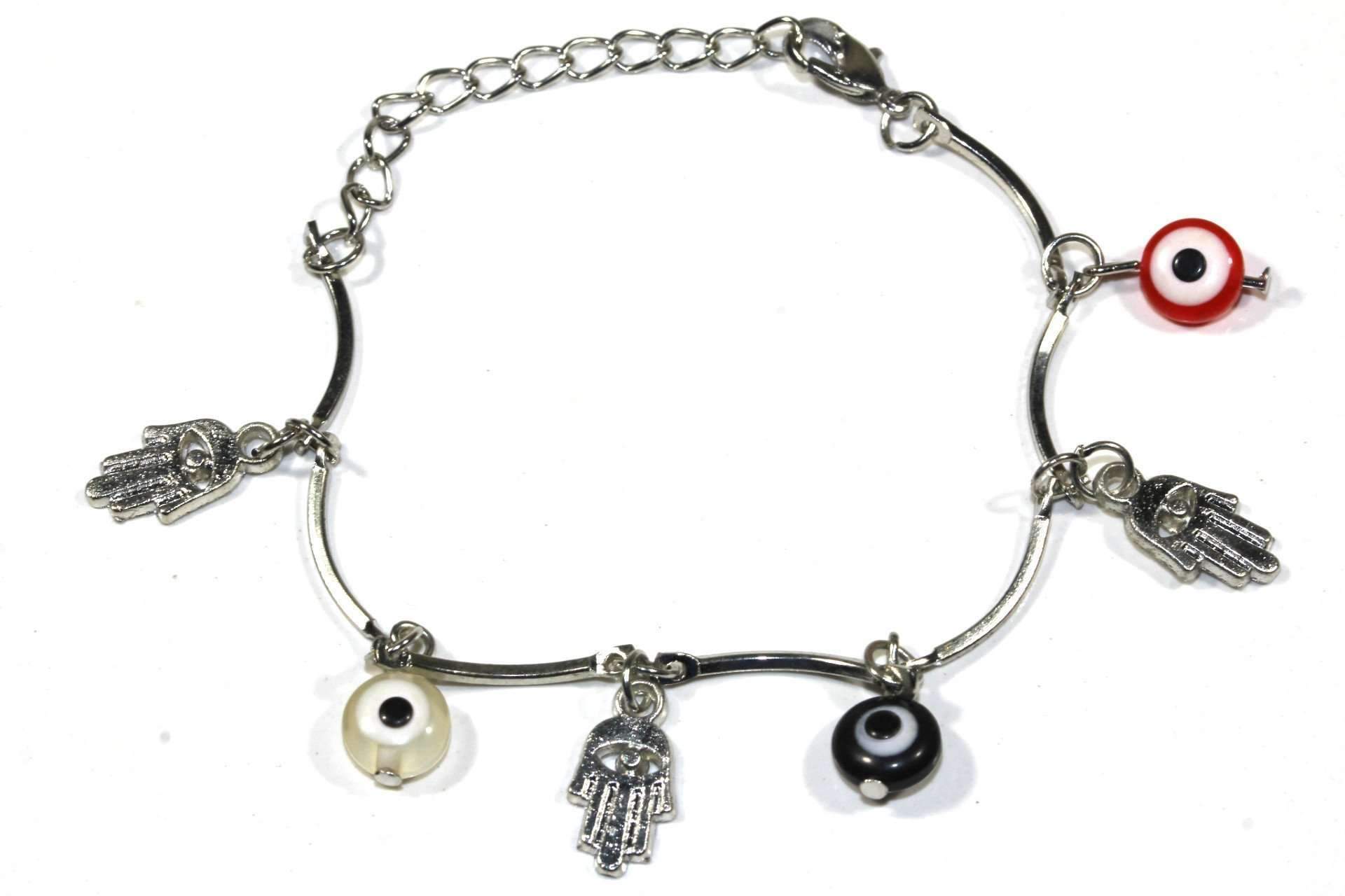 Silver Hestia Hamsa Hand and Evil Eye bracelet with intricate designs, worn on a person&