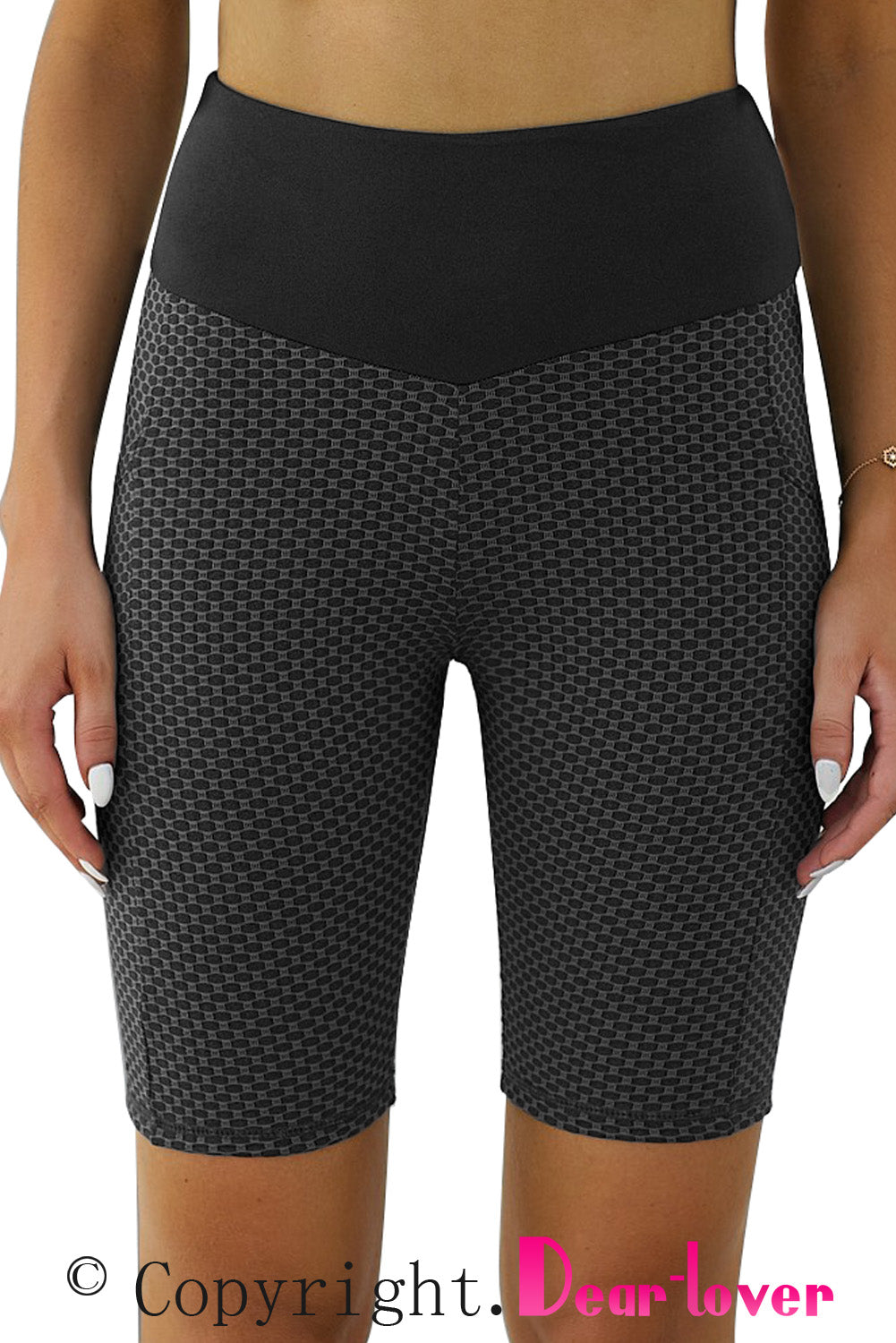 Black ruched yoga shorts with side pockets and lifting design, perfect for active wear by Harlequin Daisy.