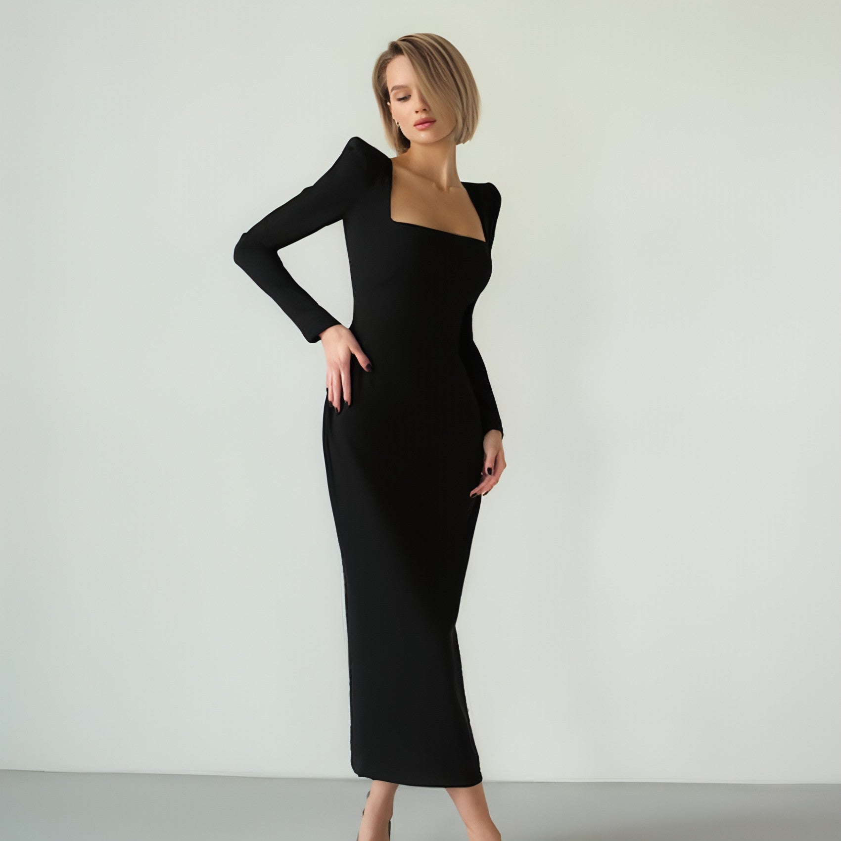 Carmine Juneberry long skirt with square neckline, slim fit, and flowing fabric, styled with a casual top.