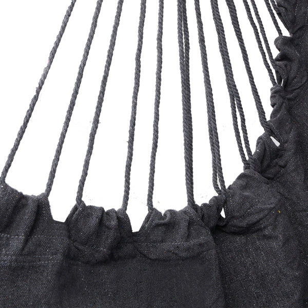 Gray LuneluX boho hanging chair by Carmine Juneberry with fringe and cushions, showcasing a cozy, stylish furniture piece.