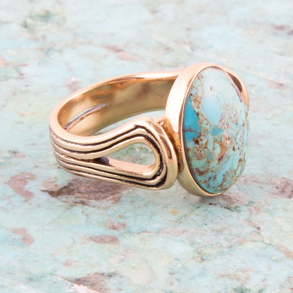 Start2Finish Nova blue turquoise and golden oval jewelry ring, showcasing a striking turquoise stone with gold accents.