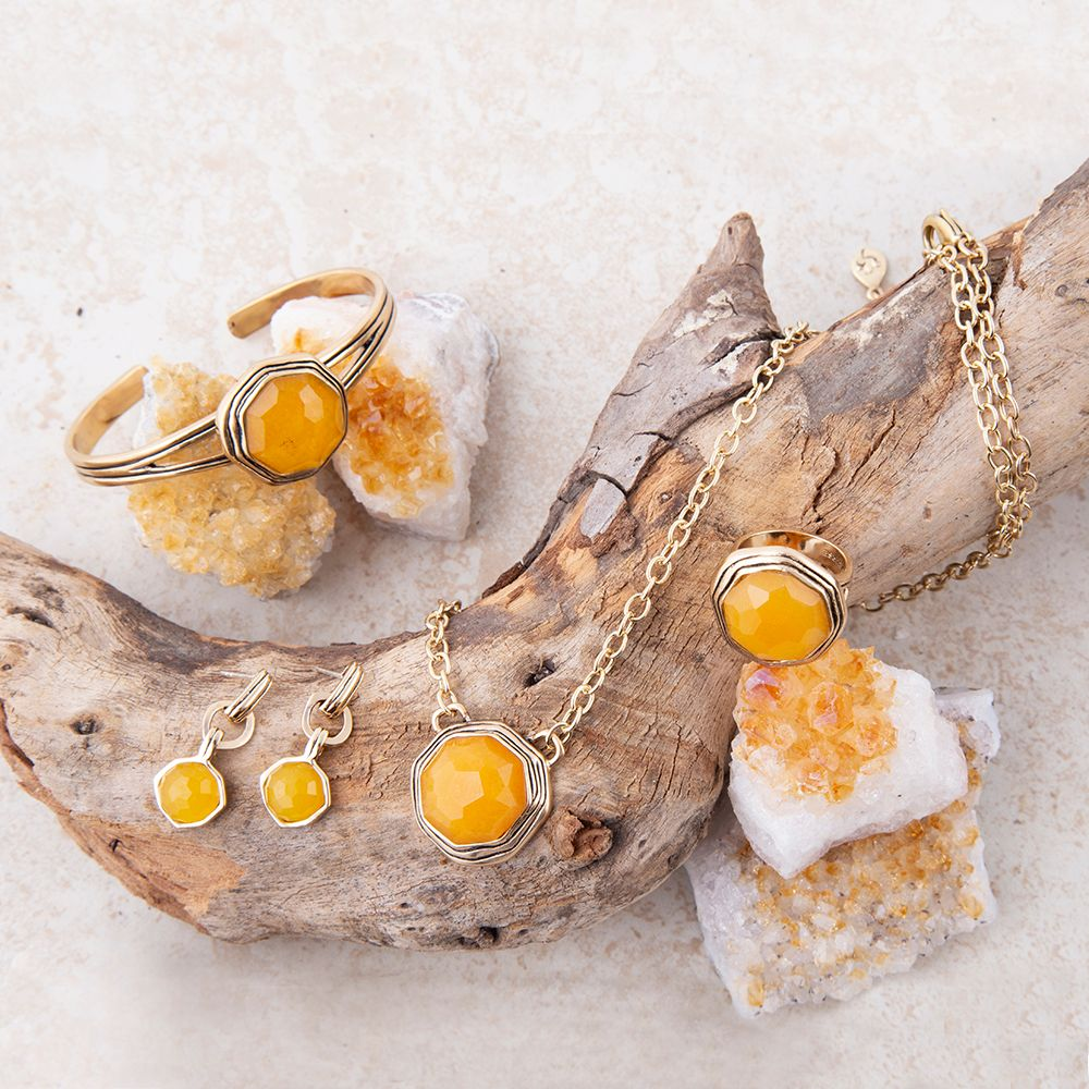 Yellow quartz river rocks and gold cuff bracelet from Start2Finish jewelry, featuring natural stone textures and metallic accents.