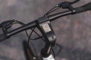 Start2Finish Carbon Black E-Bike with built-in speakers and Bluetooth, showcasing sleek design and handlebar controls.