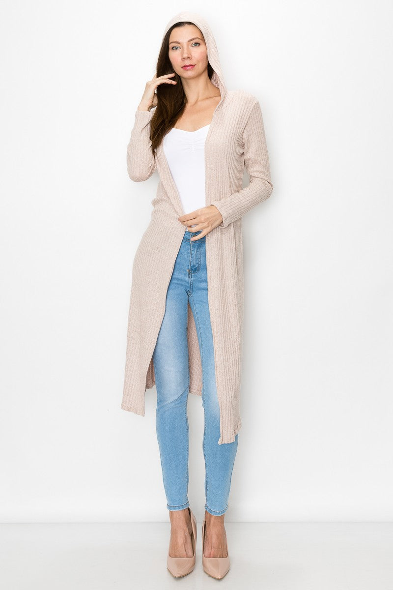 Beige long sleeve hooded light cardigan from Yellow Hera, styled as a dress, shown on a model with a casual outdoor setting.