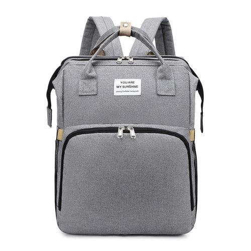 Carmine Juneberry ALLFASHION™ FoldAway BabyNest Backpack with adjustable straps and compact foldable design, shown open and packed.