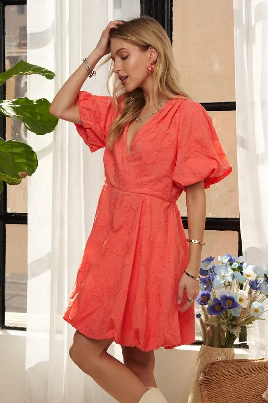 Pear Daisy ADORA puff sleeve floral dress with a fitted bodice and flowing skirt, displayed on a hanger in a home setting