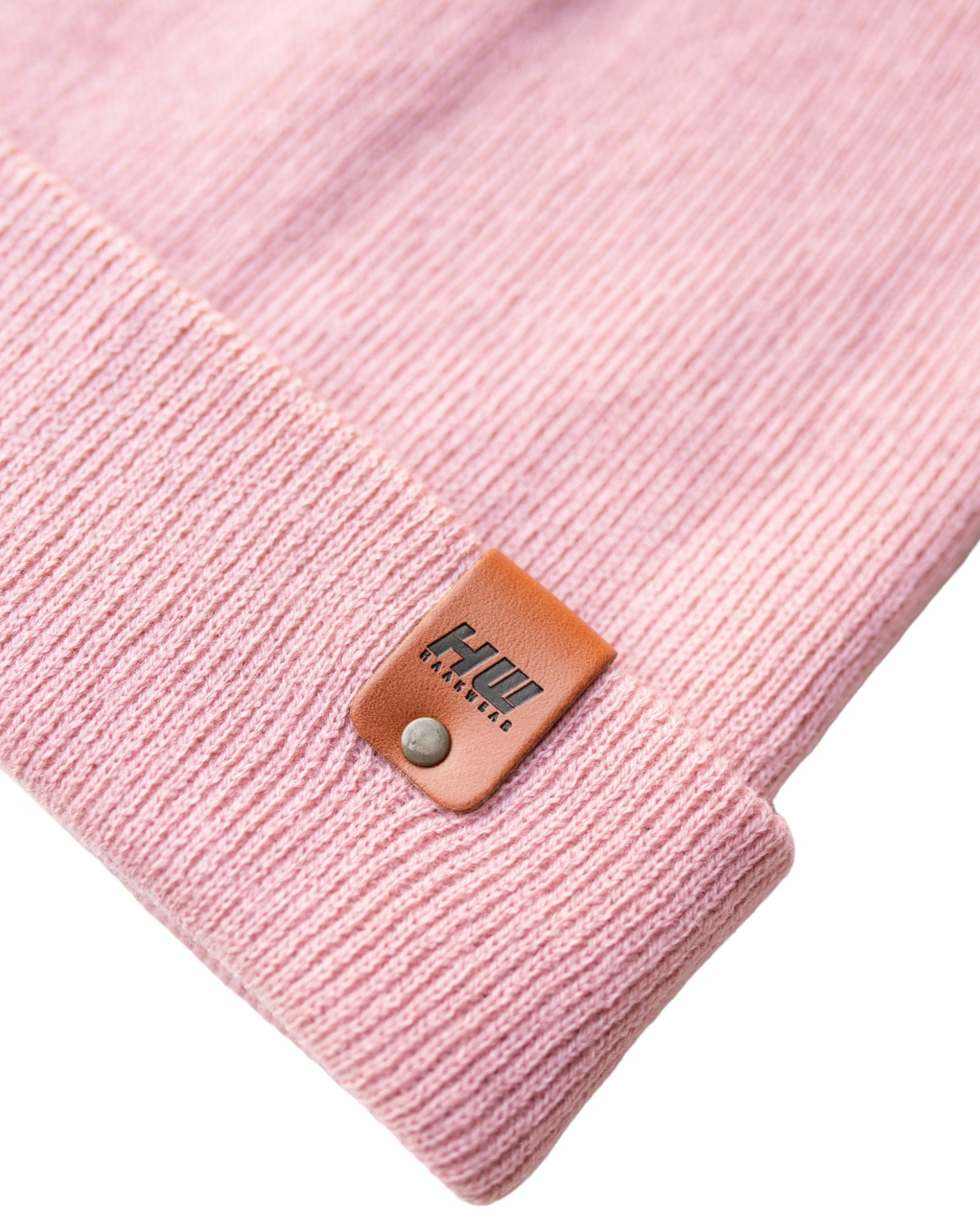 Azure Arrowwood HAAKWEAR Pearl Pink knit beanie with cuff, cozy winter hat made of soft, textured knit fabric.