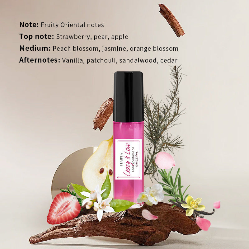 Carmine Juneberry Crazy In Love™ body perfume oil for women, featuring a small glass bottle with a rollerball applicator.