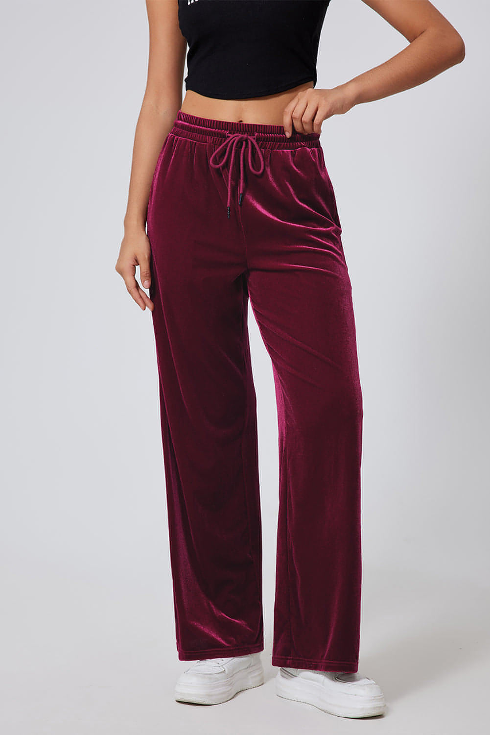 Burgundy wide-leg pants with drawstring waist from Carmine Juneberry, made of solid fabric, styled for a relaxed fit.