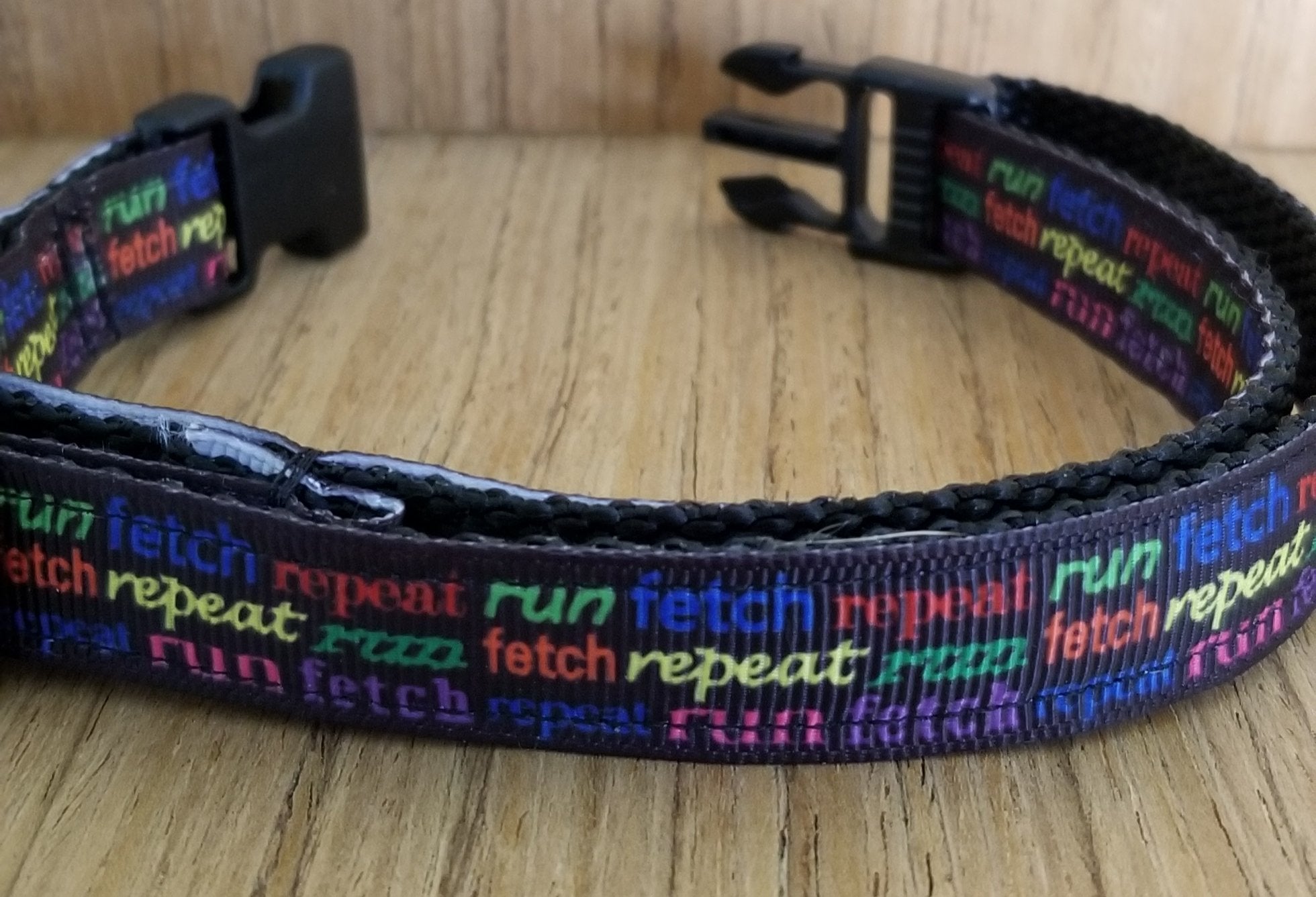 Small Green Thalassa collar with "Run Fetch Repeat" text, designed for pets, featuring a sturdy buckle and vibrant green color.