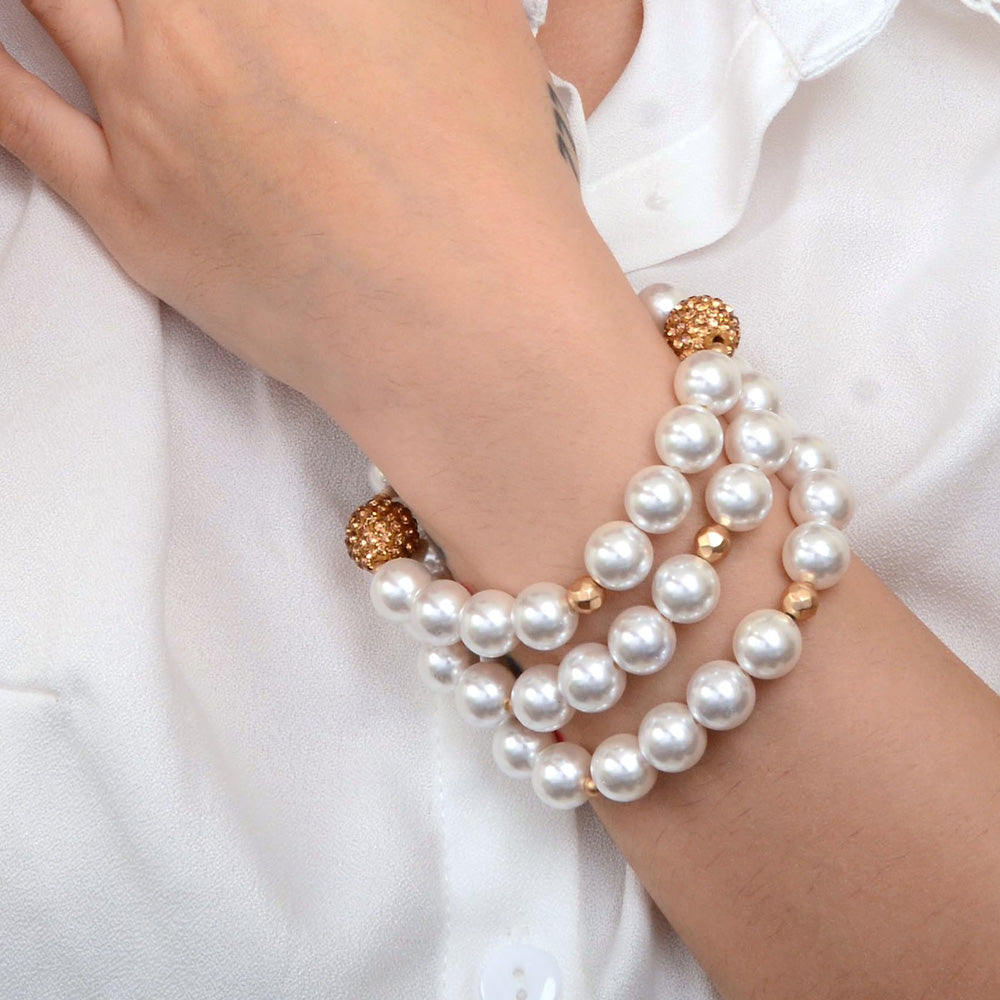 Elegant jewelry set featuring chunky white pearl and triple golden bracelets from Start2Finish, showcasing a stylish layered design.