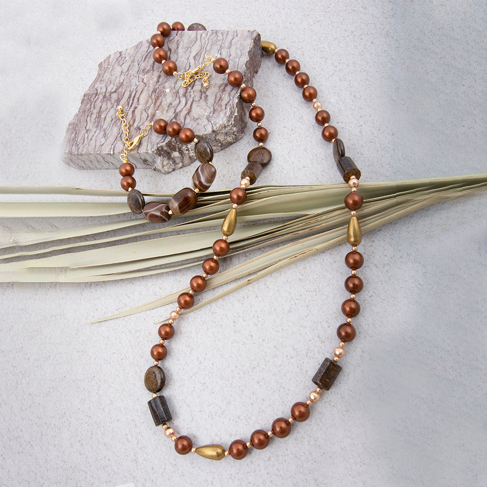 Mocha brown pearl and gold necklace from Start2Finish jewelry with a long, elegant design and intricate bead details.