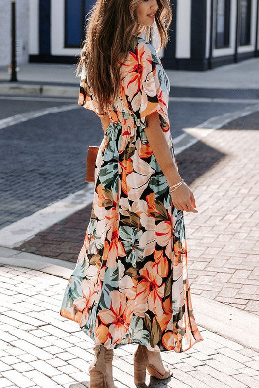Floral midi dress by Jade Icarus with vibrant flower patterns, displayed on a hanger against a plain background.