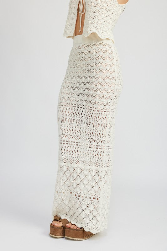 Fitted crochet maxi skirt with slit by Jade Icarus, showcasing intricate crochet pattern and stylish slit detail.