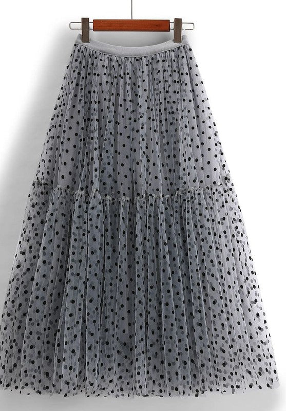 Automotive part from Jade Icarus featuring a polka dot pattern, designed as a stylish midi skirt with a playful, vintage-inspired look.