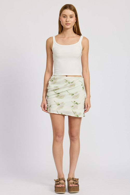 Automotive floral pencil skirt with side slit from Jade Icarus, featuring a vibrant floral pattern and sleek fit.