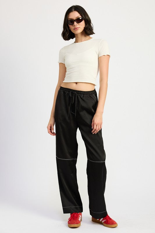 Jade Icarus satin lounge pants with contrasting stitch detail, featuring a relaxed fit and smooth fabric for comfortable wear.