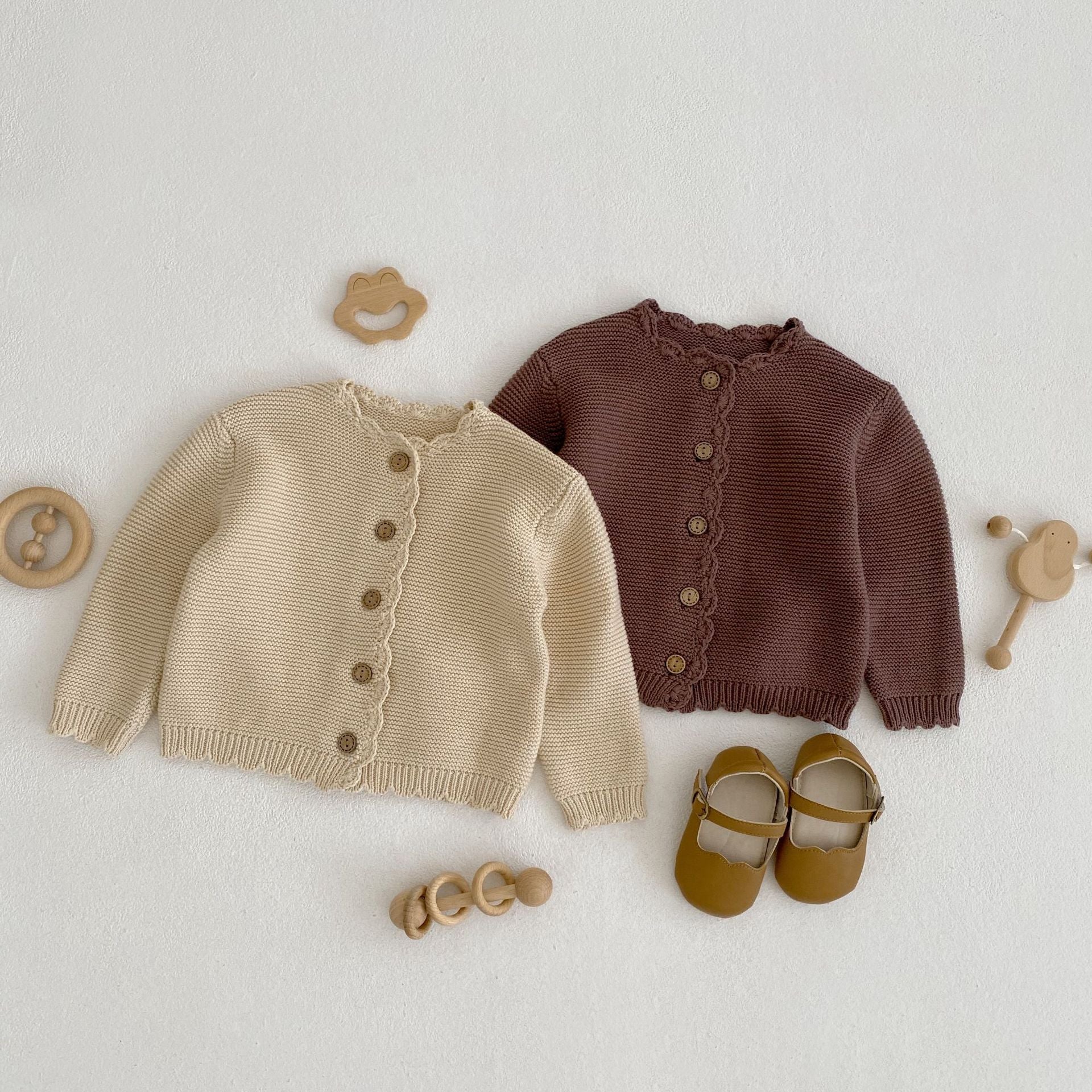 Baby unisex solid color crochet cardigan by Yellow Angel, cozy and stylish for kids and babies, shown in natural fabric detail.