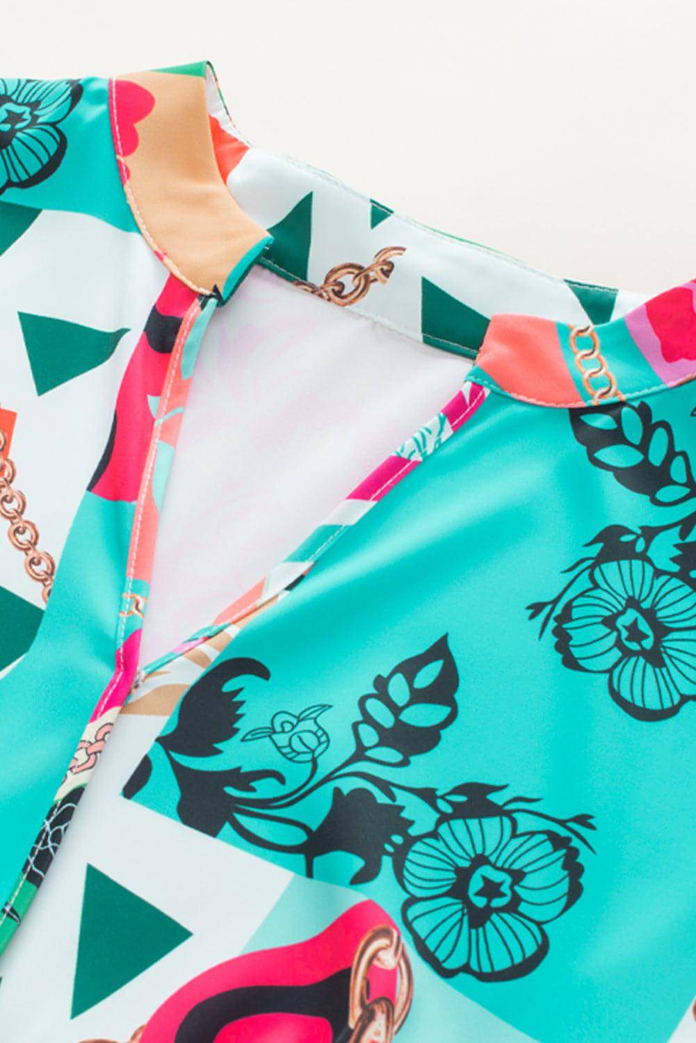 Multicolour abstract printed half sleeve mini dress with notched neckline by Carmine Juneberry, displayed on a mannequin.