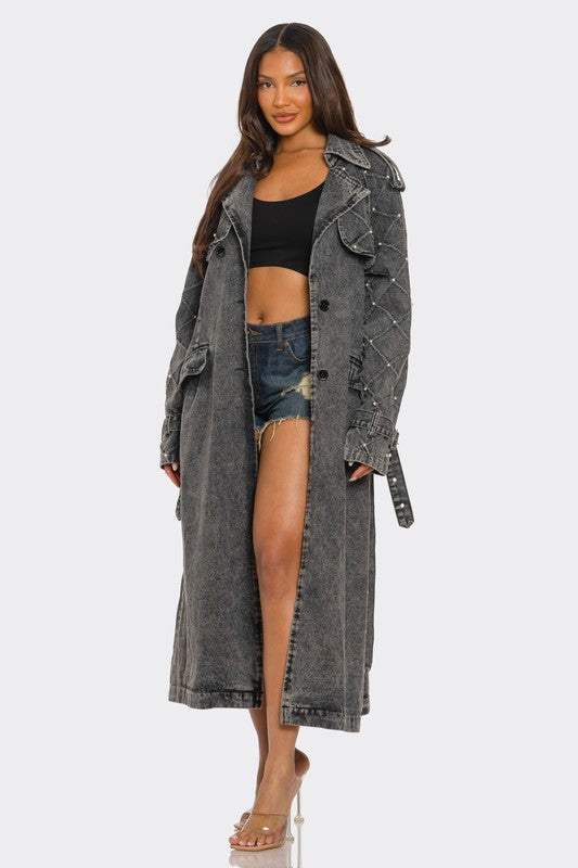 Distressed denim trench coat by Jade Icarus, automotive-themed outerwear with a rugged, worn-in look featuring distressed fabric and classic design.