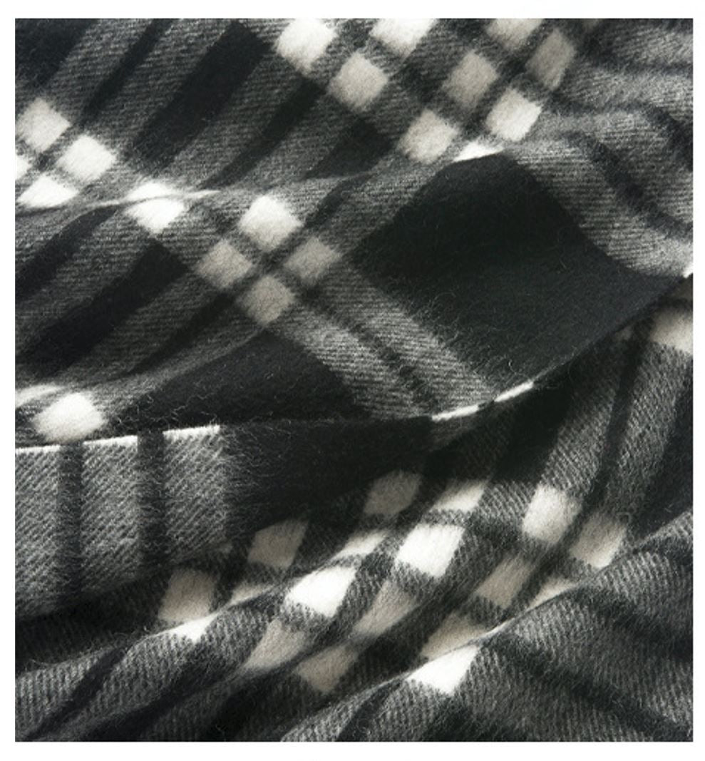 Check Lambswool Scarf by Start2Finish in black and white woven pattern, showcasing its soft, textured fabric.