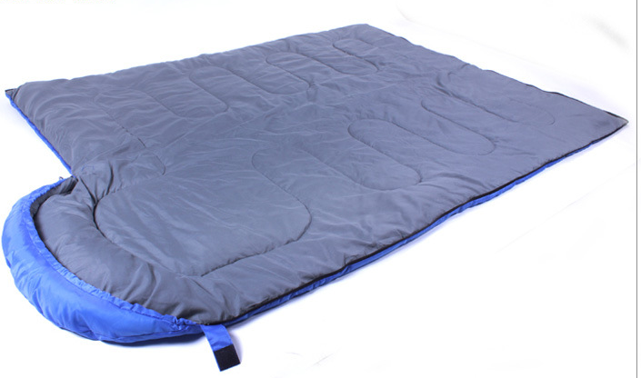 Maroon Asteria envelope camping sleeping bag made of cotton, suitable for adult campers, shown opened with its soft interior.