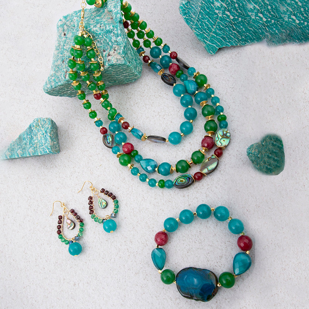Jeweled green agate statement necklace with gold accents, featuring intricate jewelry design and vibrant gemstone details.