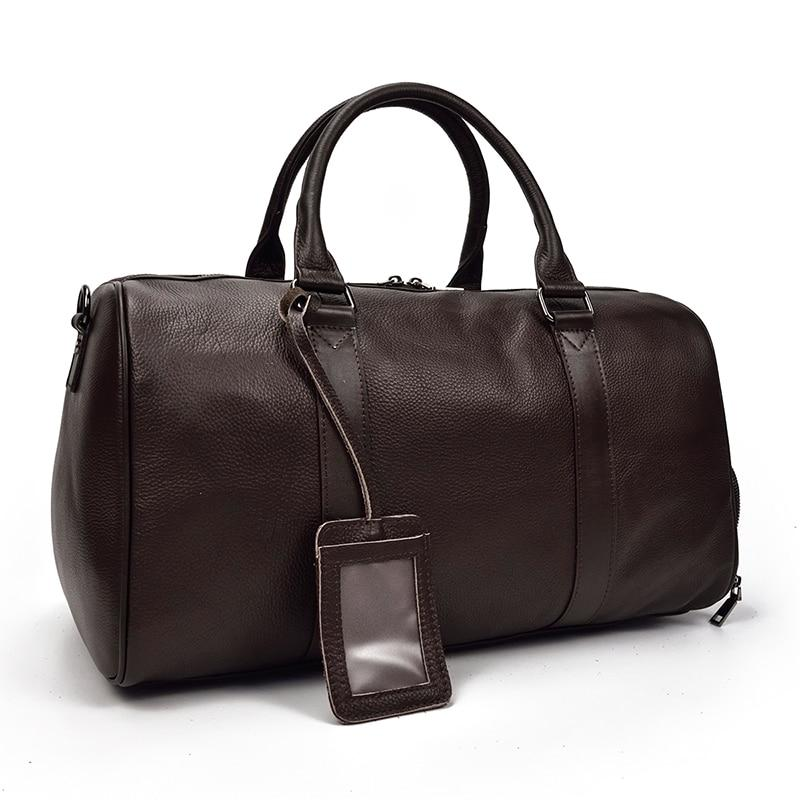 Vintage leather duffle bag, The Endre Weekender accessory by Start2Finish, with sturdy handles and spacious interior for travel.