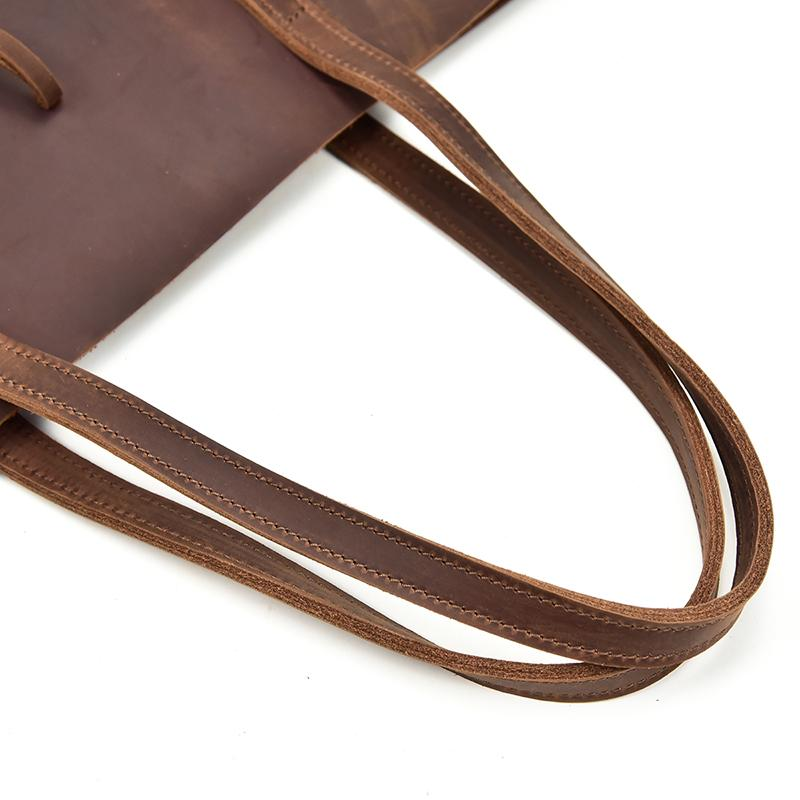 Handcrafted leather tote bag with sturdy straps and spacious interior, designed as a stylish accessory by Start2Finish.