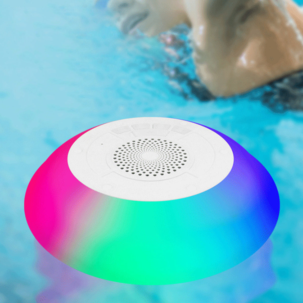 Salmon Lucky Floatilla Bluetooth waterproof speaker with LED lights, designed for pool use, showing the device floating on water.