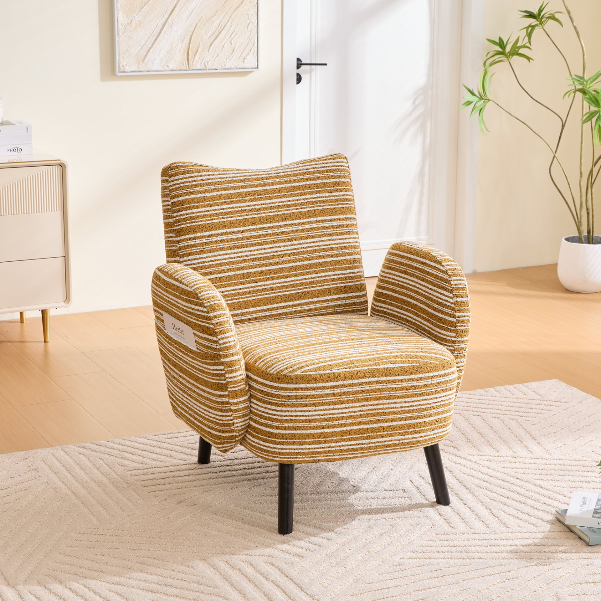 Modern armchair with sanded fabric, solid wood legs, and side storage pocket, designed by Start2Finish.
