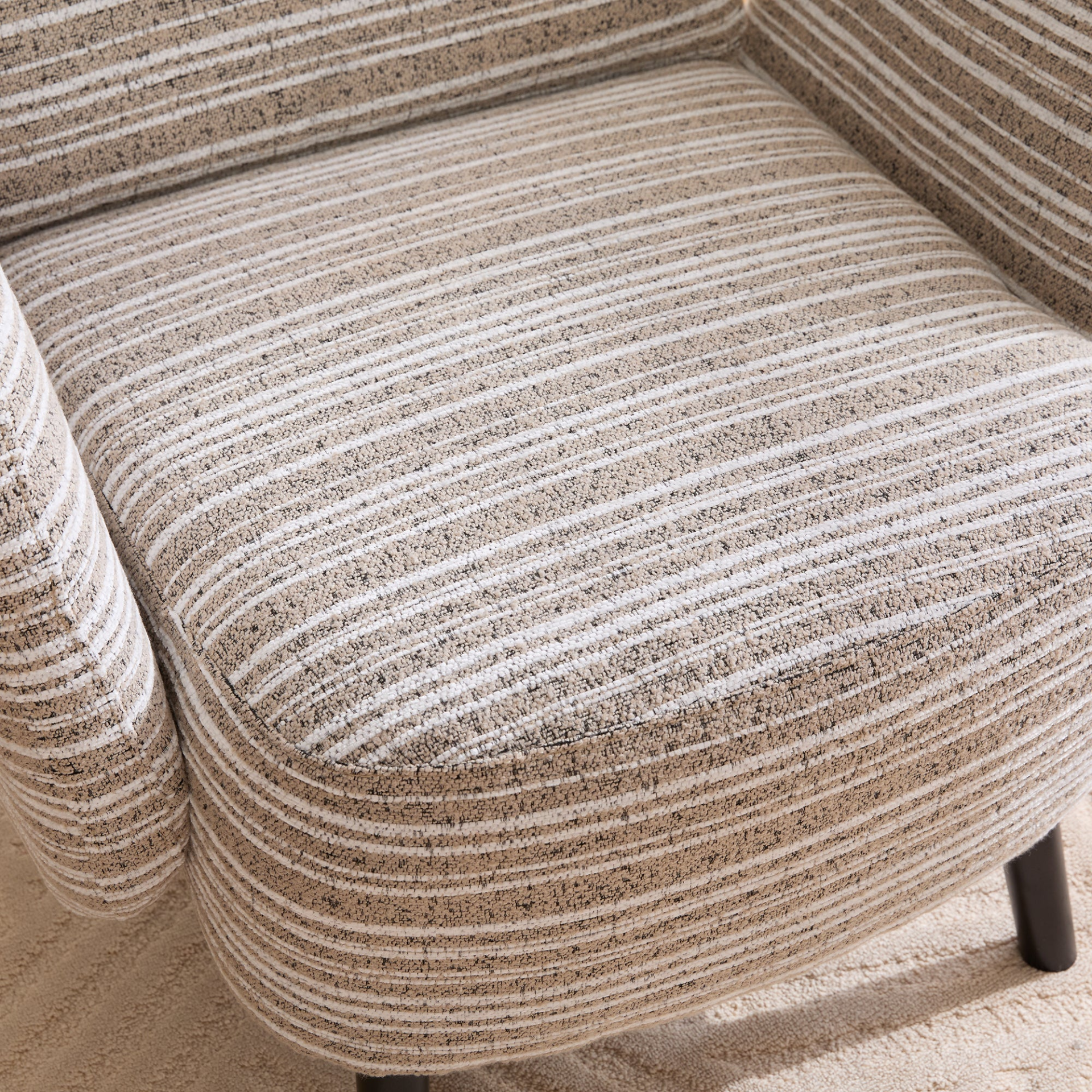 Modern armchair with sanded fabric, side storage pocket, and solid wood legs by Start2Finish, shown in a stylish living room setting.