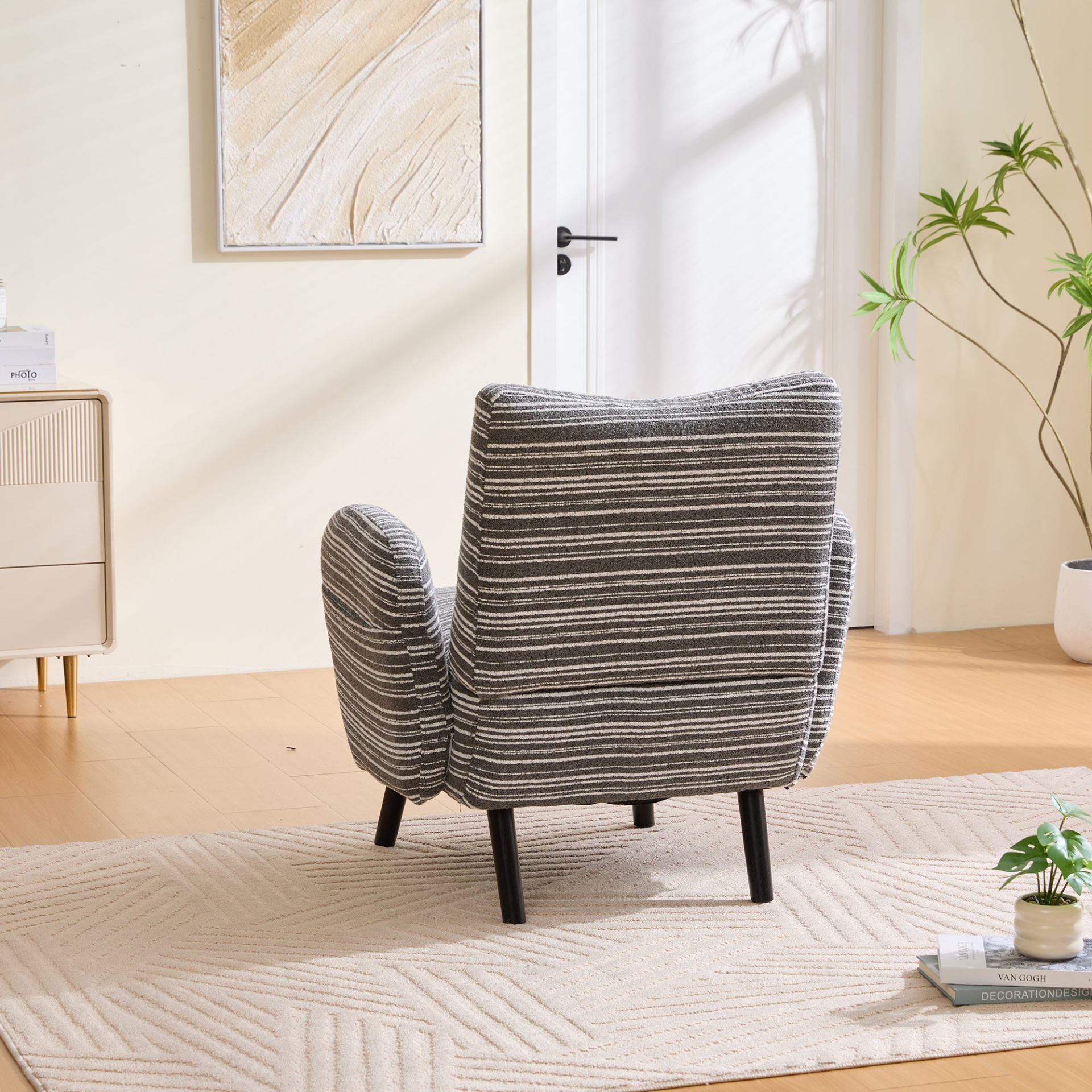 Modern armchair by Start2Finish with sanded fabric, side storage pocket, and solid wood legs, shown from a front angle.