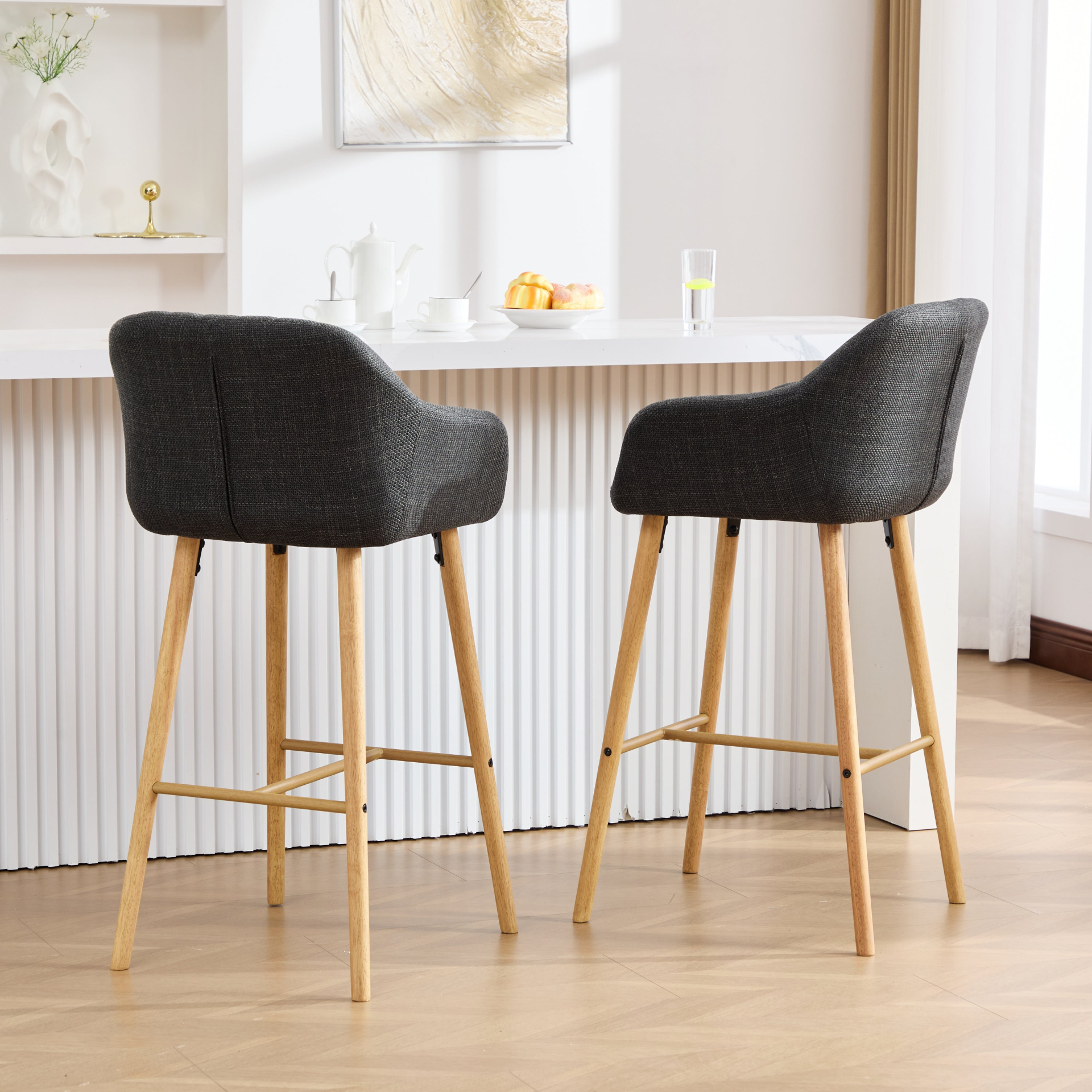 Modern linen upholstered bar stool with backrest, armrests, footrest, and solid wood legs from Start2Finish furniture.