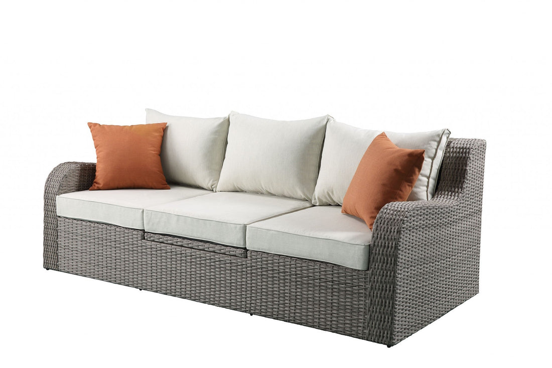 Gray wicker patio sectional and ottoman set by Jade, featuring a stylish 3-piece outdoor furniture arrangement.