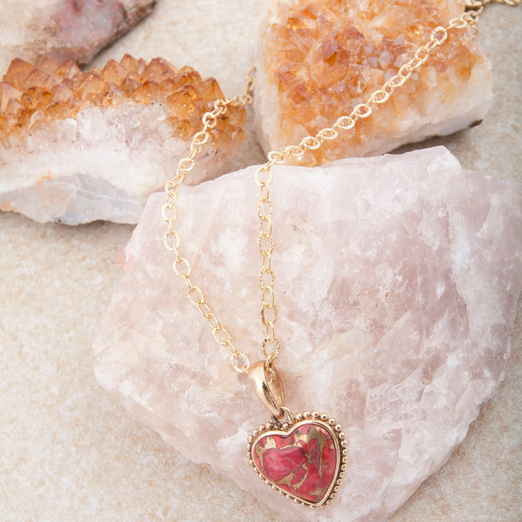 Hearts of Love Red Magnesite pendant necklace with gold chain, showcasing a heart-shaped red magnesite pendant in jewelry style.
