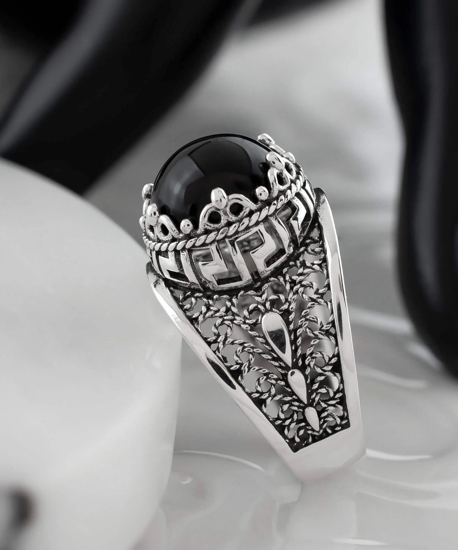 Silver cocktail ring with black onyx gemstone featuring meander pattern filigree art design for women.