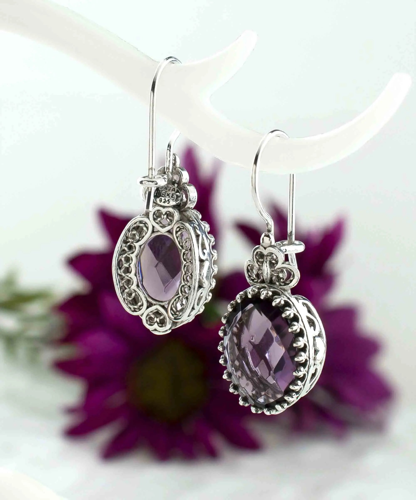 Silver oval drop earrings with filigree design, amethyst gemstone hearts, detailed jewelry for women.