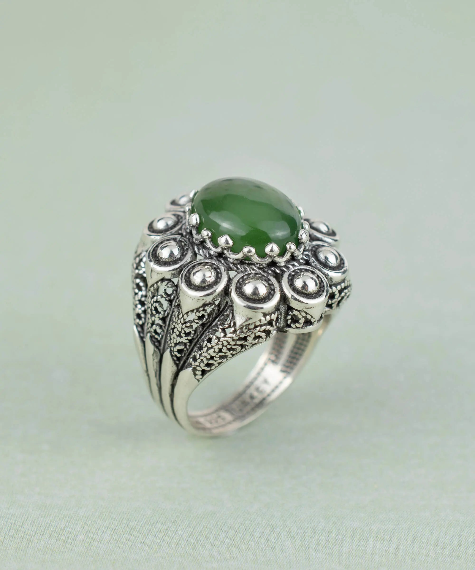 Filigree art serpentine gemstone women statement dome ring, intricate jewelry design with colorful gemstone details.