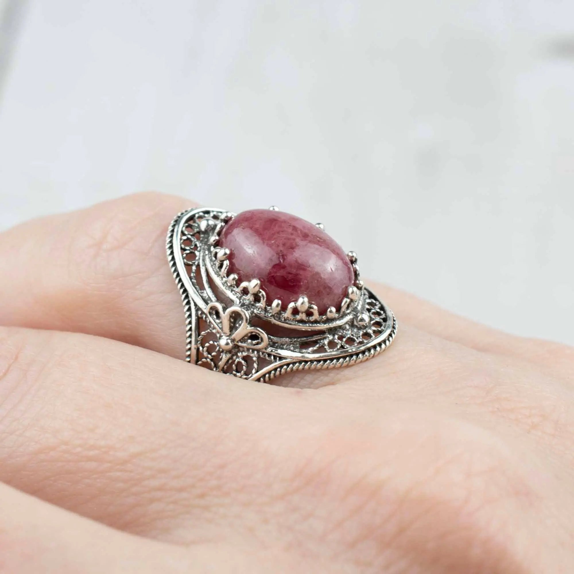 Silver statement ring featuring Rhodonite gemstone and intricate filigree art design, designed for women.