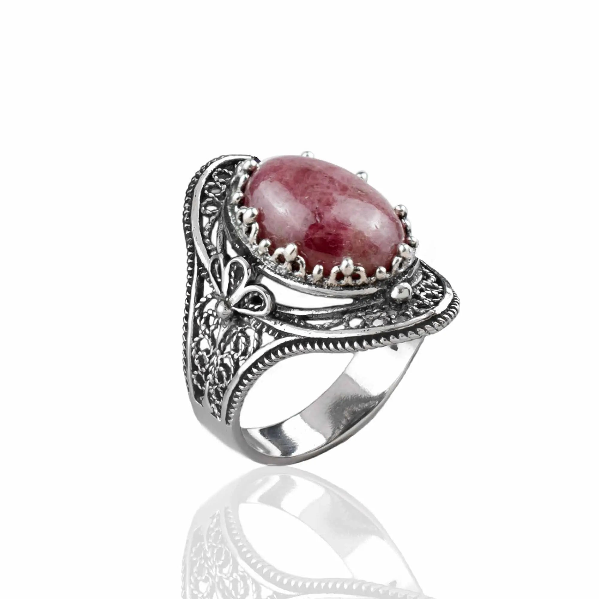Silver statement ring featuring a rhodonite gemstone with intricate filigree details and an elegant woman motif.