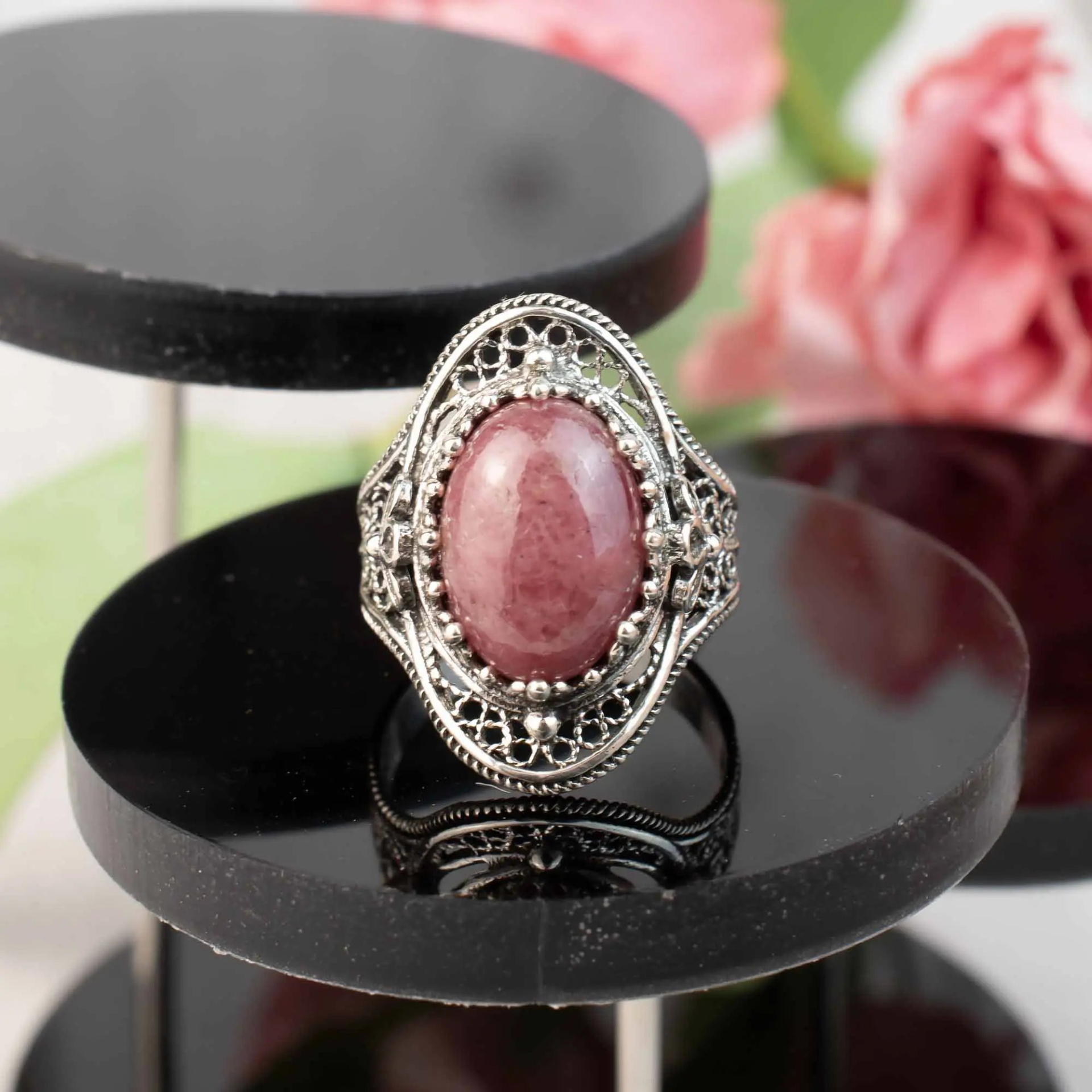 Silver statement ring with intricate filigree detailing and a central Rhodonite gemstone, designed for women.