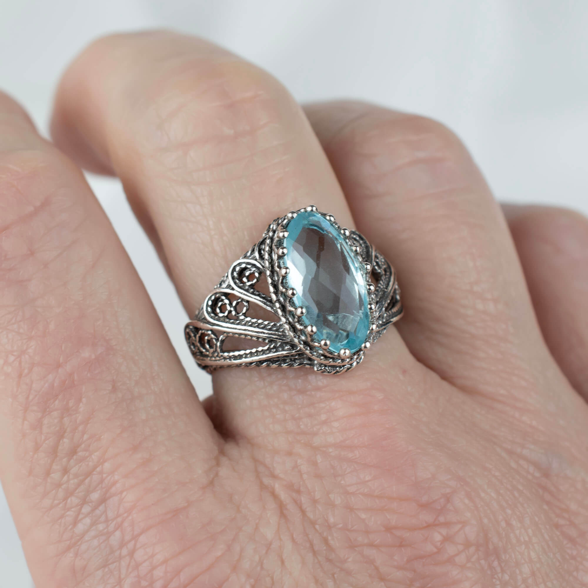 Silver cocktail ring featuring blue topaz gemstone and angel filigree design, crafted by Start2Finish for women.