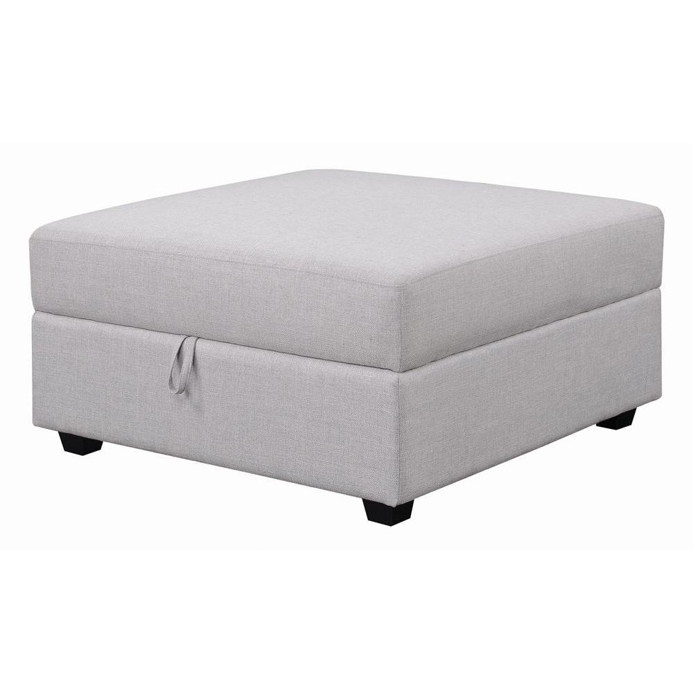Grey upholstered Cambria Square Storage Ottoman by Start2Finish with cushioned top and built-in storage space.