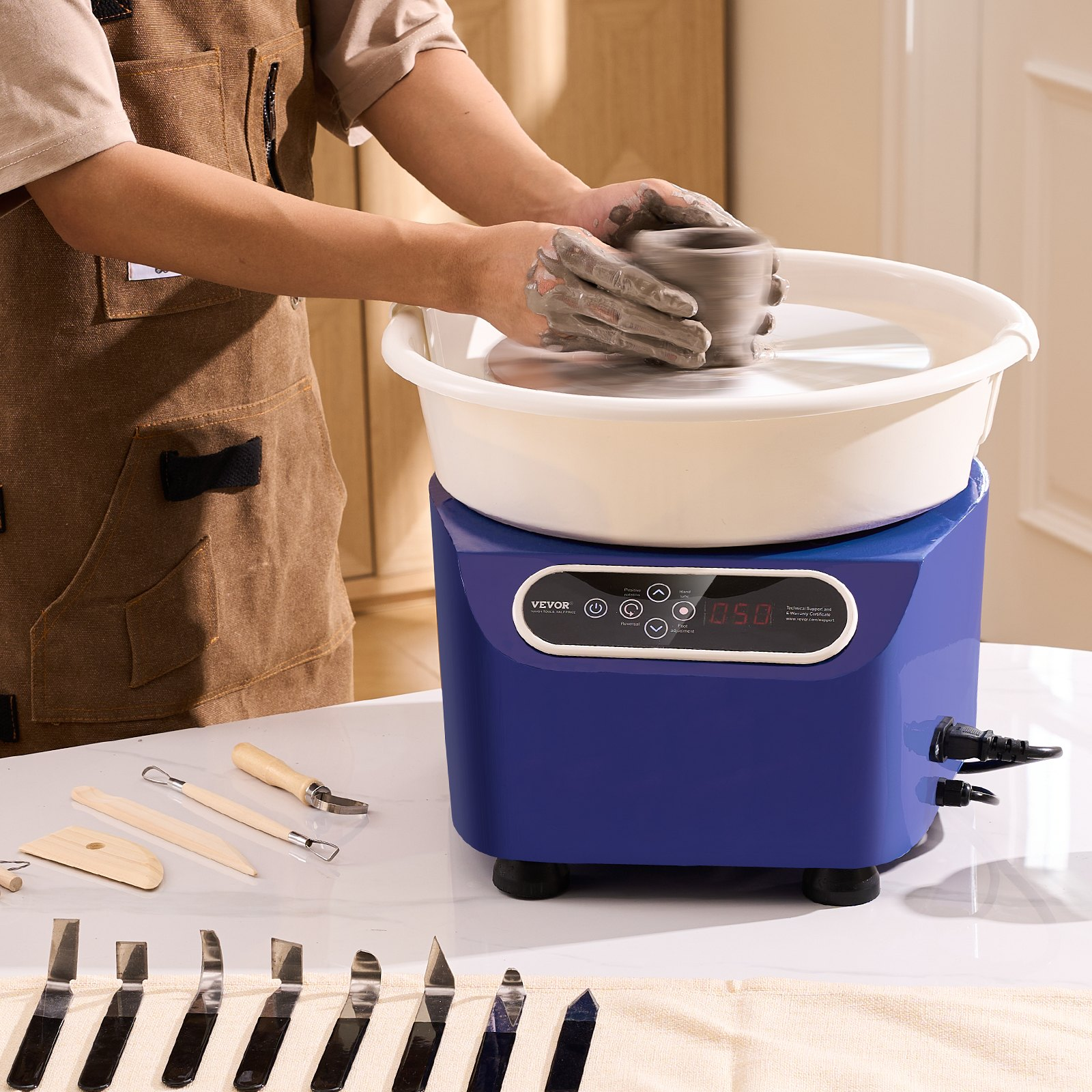 Blue VEVOR pottery wheel with LCD touch screen, foot pedal, and shaping tools for DIY ceramic art and pottery crafting.