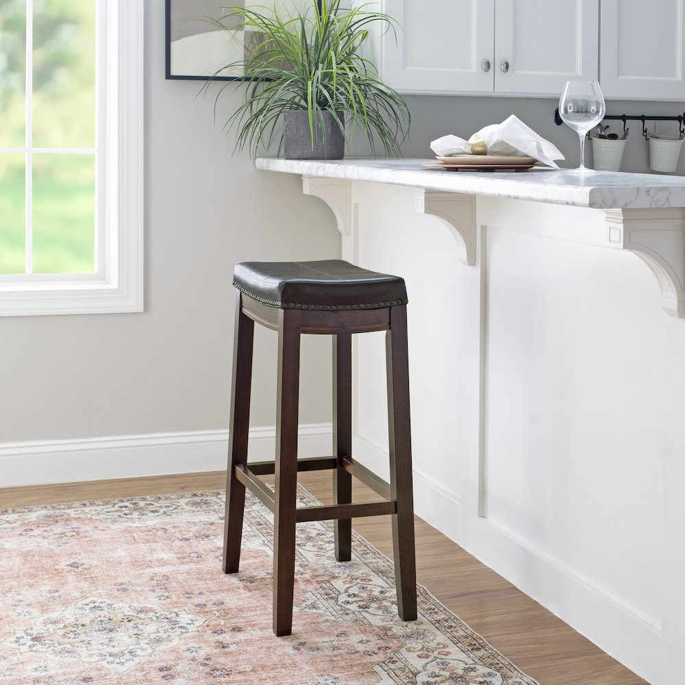 Start2Finish Claridge Brown Barstool with wooden legs and upholstered seat, shown from a side angle.