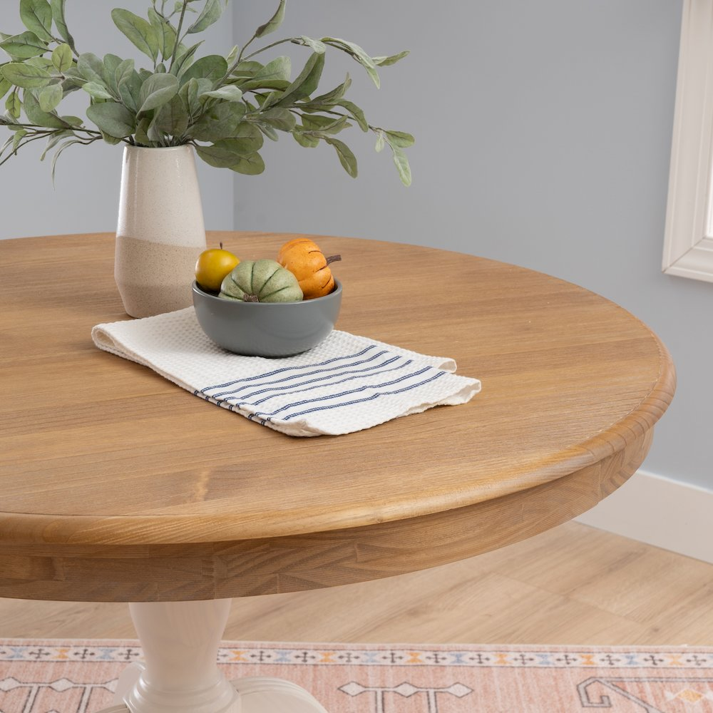 Tobin Pedestal Dining Table by Start2Finish with natural wood top and white pedestal base, shown in a modern dining room setting.