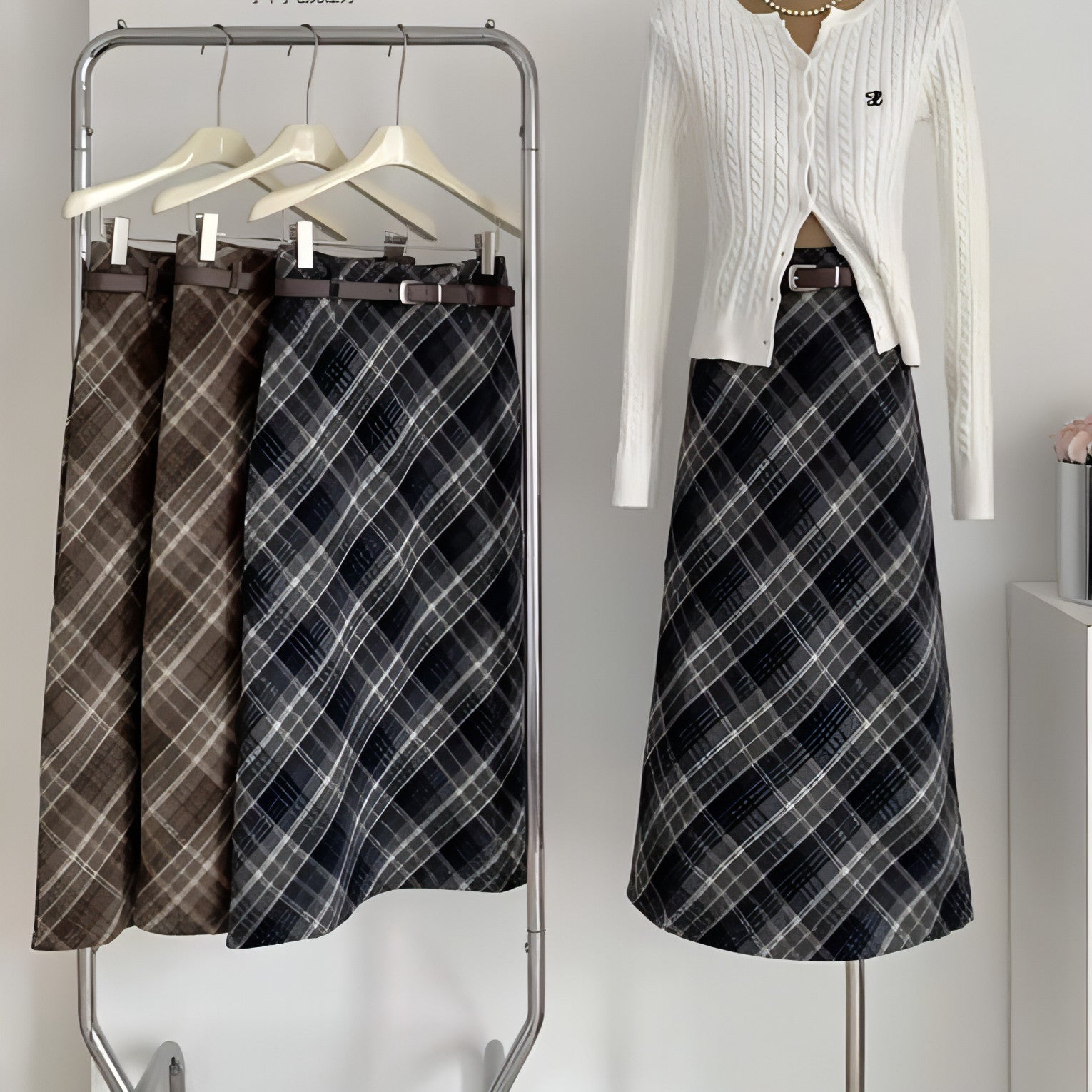 High waist mid-length woolen plaid skirt for women by Carmine Juneberry, featuring classic pattern and tailored fit.