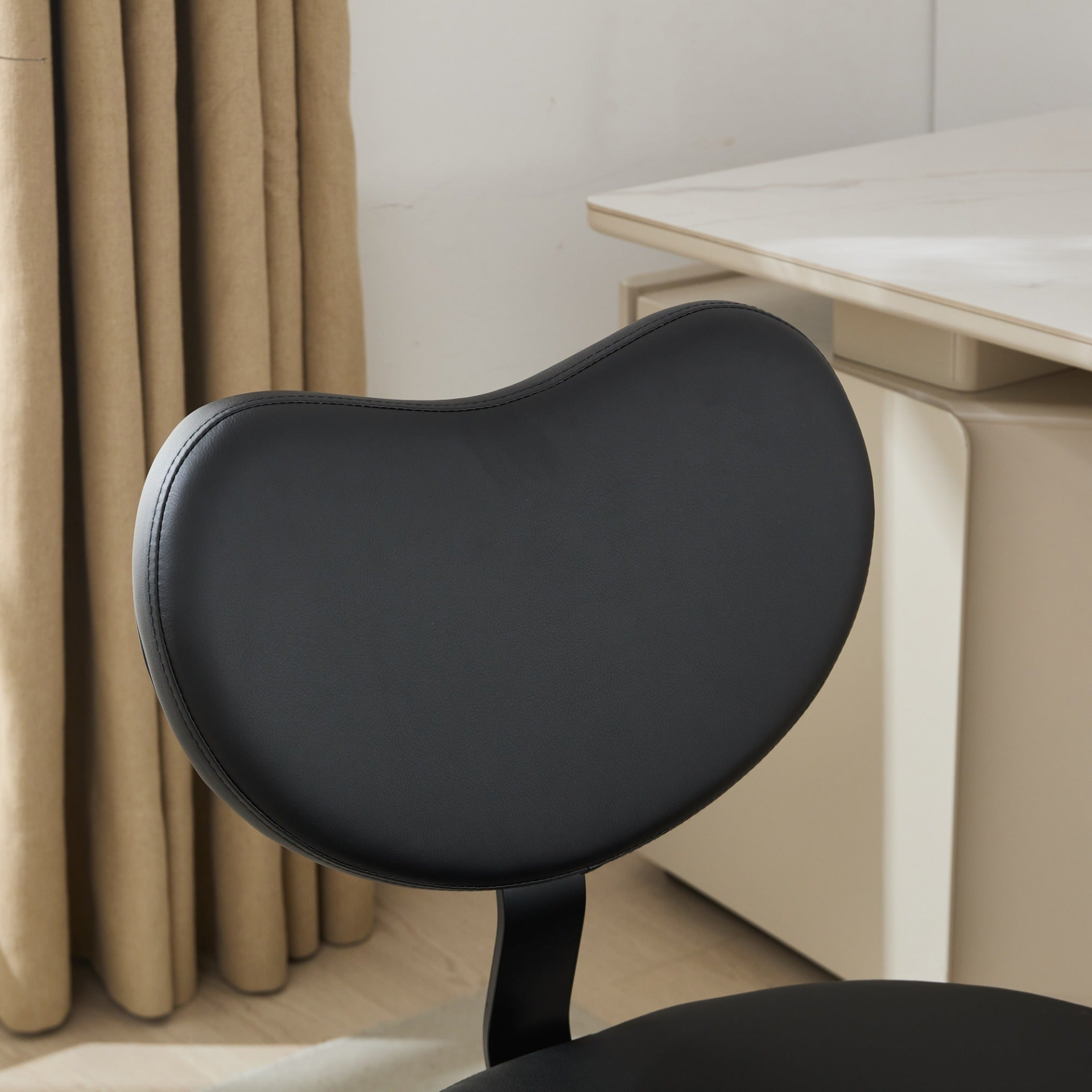 Black PU leather office chair with USB port, swivel function, and ergonomic design for home office or vanity desk.