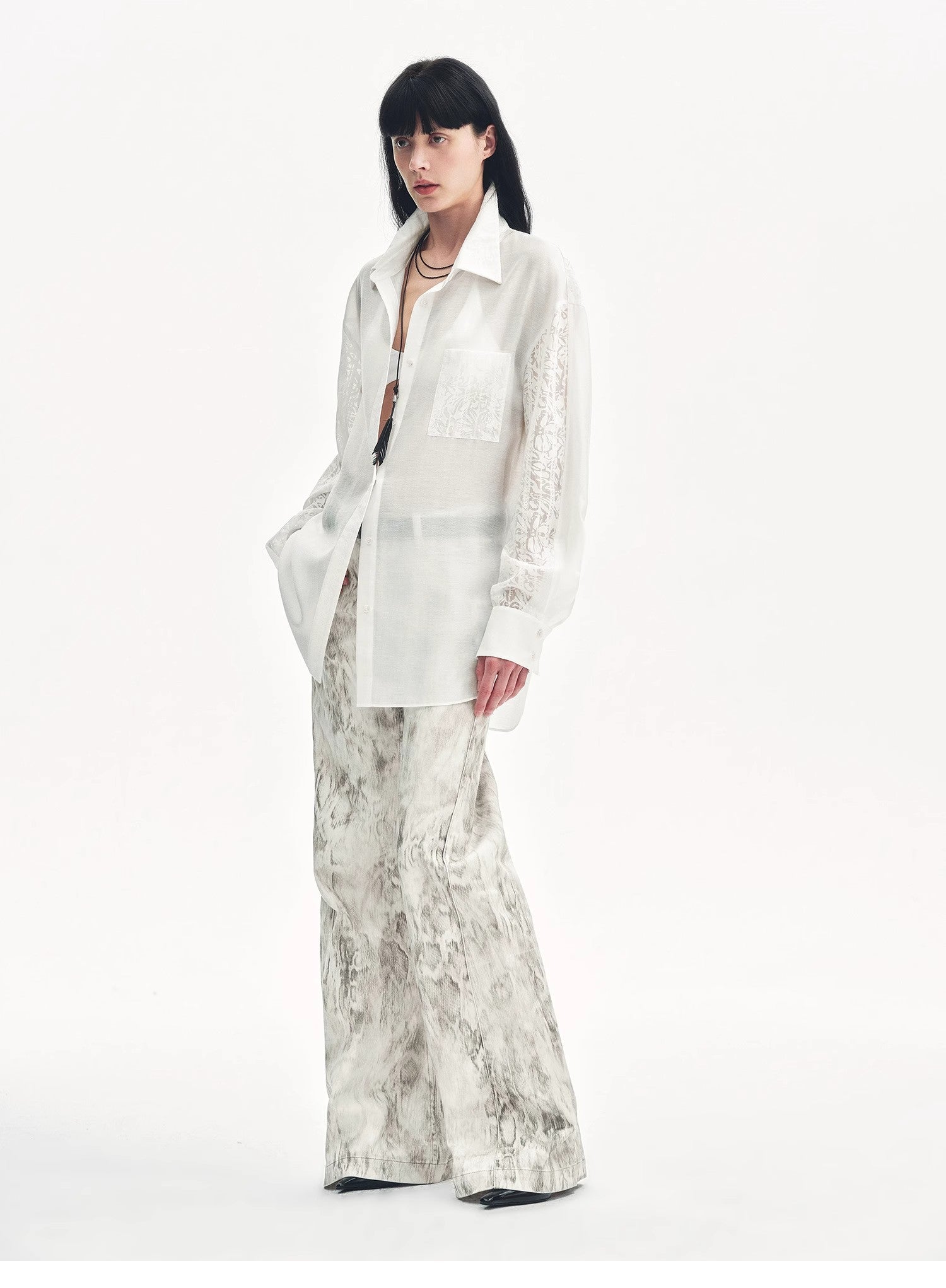 Brown Coeus Phantom snake print flared denim trousers, showcasing their unique snake pattern and high-waisted flare design.
